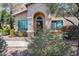 Charming home featuring a stucco facade, arched entryway, and desert landscaping at 14300 W Bell Rd # 312, Surprise, AZ 85374