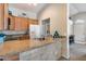 Kitchen with granite countertops, a breakfast bar, and views into the living area at 14300 W Bell Rd # 312, Surprise, AZ 85374