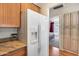 Bright kitchen featuring modern white appliances and an adjacent doorway to the bedroom at 14300 W Bell Rd # 312, Surprise, AZ 85374
