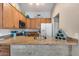 Bright kitchen featuring granite countertops, stainless steel appliances, and ample cabinet space at 14300 W Bell Rd # 312, Surprise, AZ 85374