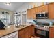Kitchen featuring granite counters, wood cabinetry, and stainless steel appliances at 14300 W Bell Rd # 312, Surprise, AZ 85374