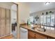 A kitchen view with granite countertops, sink, and view to the living room at 14300 W Bell Rd # 312, Surprise, AZ 85374