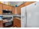 Kitchen featuring wood cabinets, granite countertops, and stainless steel appliances at 14300 W Bell Rd # 312, Surprise, AZ 85374