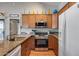 Kitchen featuring wood cabinets, granite countertops, stainless steel appliances and wood flooring at 14300 W Bell Rd # 312, Surprise, AZ 85374