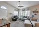 Inviting living room featuring comfortable seating, ceiling fan, and bright natural light at 14300 W Bell Rd # 312, Surprise, AZ 85374