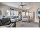 Bright living room featuring neutral furniture, shuttered windows, and a ceiling fan at 14300 W Bell Rd # 312, Surprise, AZ 85374