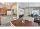 Open-concept living space with a kitchen bar and dining area flowing into the living room at 14300 W Bell Rd # 312, Surprise, AZ 85374