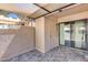 Tiled patio featuring a sliding glass door, a storage closet, and a shaded canopy at 14300 W Bell Rd # 312, Surprise, AZ 85374