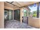 This covered patio has tile flooring, outdoor lighting, and access to the interior through sliding glass doors at 14300 W Bell Rd # 312, Surprise, AZ 85374