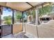This patio features a stucco privacy wall, a metal fence, and desert landscaping with greenery and trees at 14300 W Bell Rd # 312, Surprise, AZ 85374