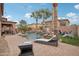 Relaxing backyard with pool, lounge chairs, and a covered patio at 14517 W Cortez St, Surprise, AZ 85379