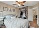 Comfortable bedroom with wood floors, closet with custom wall paper and overhead ceiling fan at 14517 W Cortez St, Surprise, AZ 85379