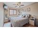 Cozy bedroom features wood floors, ceiling fan, shuttered windows, and soothing paint at 14517 W Cortez St, Surprise, AZ 85379