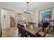 Cozy dining area with a wooden table and a glimpse into the living area, perfect for casual dining and entertaining at 14517 W Cortez St, Surprise, AZ 85379