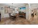Elegant dining area with a wooden table, shuttered windows, and a stylish wine storage, perfect for dinner parties at 14517 W Cortez St, Surprise, AZ 85379