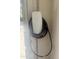 Installed Tesla EV charger on garage wall ready to charge your electric vehicle at 14517 W Cortez St, Surprise, AZ 85379