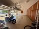 Large three car garage with custom cabinet storage, epoxy floors, and room for vehicles at 14517 W Cortez St, Surprise, AZ 85379
