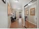 Hallway with wood floors, mirror closet doors, and charming shutters over the windows at 14517 W Cortez St, Surprise, AZ 85379