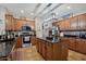 A kitchen featuring wood cabinets, black countertops, and a central island with pendant lighting at 14517 W Cortez St, Surprise, AZ 85379