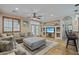 Comfortable living area featuring a sectional sofa, a built-in entertainment center, and access to the outdoor patio at 14517 W Cortez St, Surprise, AZ 85379