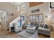 Bright living room with high ceilings, large windows, and a comfortable sectional sofa for relaxing and entertaining at 14517 W Cortez St, Surprise, AZ 85379