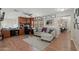 A spacious living room featuring hardwood floors, a cozy couch, and custom wood cabinets at 14517 W Cortez St, Surprise, AZ 85379
