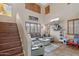 Cozy living room featuring high ceilings, a sectional sofa, and natural light at 14517 W Cortez St, Surprise, AZ 85379