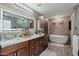 A serene main bathroom includes double sinks, cabinets, a soaker tub, and modern fixtures at 14517 W Cortez St, Surprise, AZ 85379