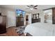 Main bedroom featuring dark wood furniture, en-suite bathroom, and a ceiling fan at 14517 W Cortez St, Surprise, AZ 85379