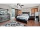 The main bedroom suite showcases a wood accent wall, sliding barn door, and ceiling fan at 14517 W Cortez St, Surprise, AZ 85379