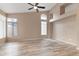 Large bedroom with vaulted ceiling, fan, light wood floors, arched window, and unique wall insets at 15032 N 54Th Pl, Scottsdale, AZ 85254