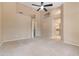 Bedroom boasting neutral carpeting, ceiling fan, and arched ceiling alcoves for decor at 15032 N 54Th Pl, Scottsdale, AZ 85254