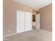 Bedroom with carpet flooring and white doors, offering ample space and comfort at 15032 N 54Th Pl, Scottsdale, AZ 85254