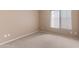 Cozy bedroom with neutral paint, plush carpeting, and bright window lighting at 15032 N 54Th Pl, Scottsdale, AZ 85254