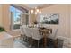 Dining area with a dining table and view from a large window at 15032 N 54Th Pl, Scottsdale, AZ 85254