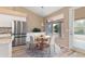 Bright dining area features a round table, four chairs, light wood floors, and a sliding glass door to the outdoors at 15032 N 54Th Pl, Scottsdale, AZ 85254