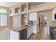 Open kitchen features granite counters, stainless steel appliances, white cabinets, light wood floors, and lots of natural light at 15032 N 54Th Pl, Scottsdale, AZ 85254