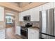 Bright kitchen showcasing stainless steel appliances and white cabinetry at 15032 N 54Th Pl, Scottsdale, AZ 85254