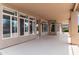 Covered patio with neutral colored floor and view of the landscaped yard through the many windows at 15032 N 54Th Pl, Scottsdale, AZ 85254