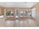 Bright sun room with light wood floors and lots of windows and sliding glass doors overlooking the landscaped back yard at 15032 N 54Th Pl, Scottsdale, AZ 85254
