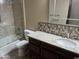Well-lit bathroom featuring granite countertops, tiled walls, modern fixtures, and a shower over bath at 15625 N Jerry St, Surprise, AZ 85378