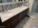 Double vanity with granite countertops, dark wood cabinets, and decorative tile backsplash in luxurious bathroom at 15625 N Jerry St, Surprise, AZ 85378