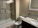 Bathroom featuring a shower-over-tub, toilet, and vanity with decorative backsplash at 15625 N Jerry St, Surprise, AZ 85378