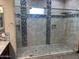 Modern bathroom featuring a glass shower stall, square shower head, and patterned mosaic tile accents at 15625 N Jerry St, Surprise, AZ 85378