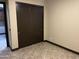 Bedroom featuring a closet with sliding doors and neutral colored walls at 15625 N Jerry St, Surprise, AZ 85378
