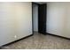 An empty bedroom with dark trim, sleek tile floor, and an open door to another space at 15625 N Jerry St, Surprise, AZ 85378
