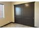 Bedroom featuring earth tone walls, marble tile floors, and a closet with arched doors at 15625 N Jerry St, Surprise, AZ 85378