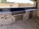 The outdoor kitchen includes a built-in grill, countertop space, and a mini refrigerator at 15625 N Jerry St, Surprise, AZ 85378