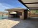 The cabana features granite countertops, a sink, and a built-in grill at 15625 N Jerry St, Surprise, AZ 85378