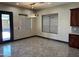 This dining room has tile floors, modern lighting, and views of the backyard at 15625 N Jerry St, Surprise, AZ 85378